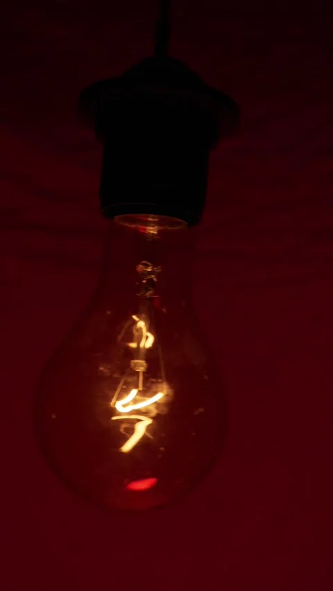 Glowing Incandescent Light Bulb Over Red Background Lighting Stock Footage 333829310