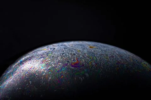Glowing iridescent soap bubble edge macro against dark background Stock Illustration