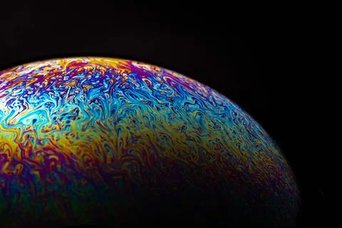 Glowing iridescent soap bubble edge macro against dark background Stock Illustration