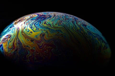 Glowing iridescent soap bubble edge macro against dark background Stock Illustration