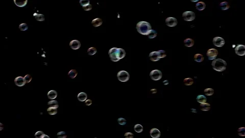 Glowing iridescent soap bubbles floating isolated over dark black backgroun.. Stock Footage 344818250