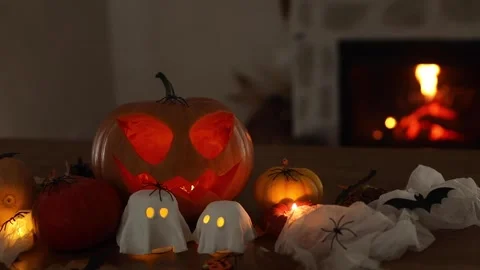 Glowing Jack o lantern and ghosts, spiders, pumpkins Stock Footage 284070699