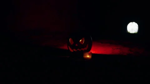 Glowing Jack O Lantern And Candle in Dark Tunnel With Bright Light at Tunnel End Stock Footage 337106106