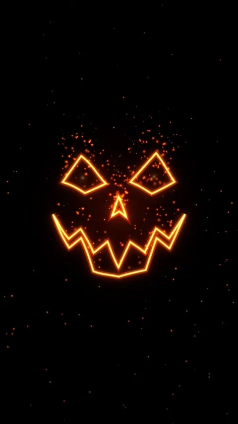 Glowing jack o lantern face with sparkling particles on black background ha.. Видео 343878943