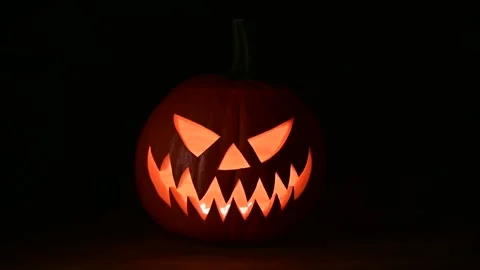 Glowing jack-o-lantern lit from inside with candles Video stock 313630606