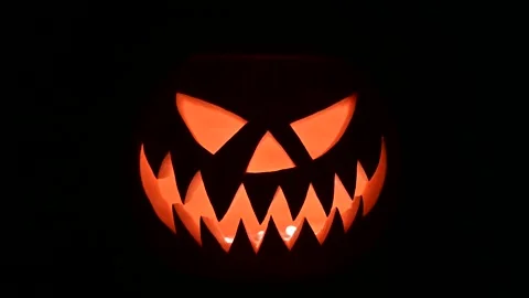 Glowing jack-o-lantern lit from inside Video stock 317693878