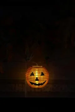 Glowing Jack-o'-Lantern Paper Lantern Hanging Outdoors during Halloween Night Stock Photos