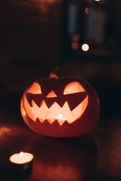 Glowing Jack-o'-lantern pumpkin with scary face for Halloween decoration Stock Photos