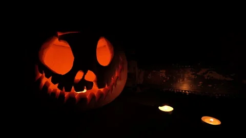 Glowing Jack-o'-Lantern with Tea Light Candles in Dark Setting Stock Footage 342562862