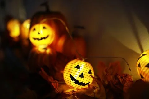 Glowing Jack-o'-Lanterns Amid Autumn Leaves - Halloween Night Decoration Stock Photos