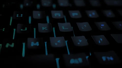 Glowing keyboard hackier style glittering at the night workplace with different Stock Footage 90314195