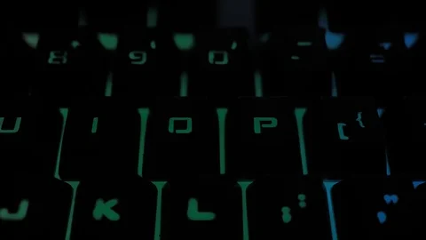 Glowing keyboard hackier style glittering at the night workplace with different Stock Footage 90314200