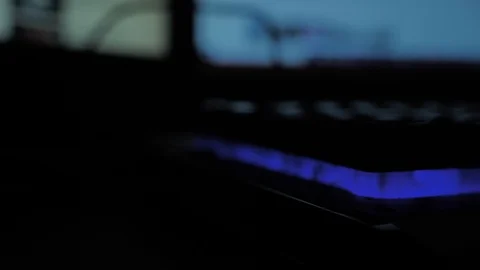 Glowing keyboard hackier style glittering at the night workplace with different Stock Footage 90314261