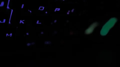 Glowing keyboard hackier style glittering at the night workplace with different Stock Footage 90314350