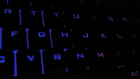 Glowing keyboard hackier style glittering at the night workplace with different Stock Footage 90314397