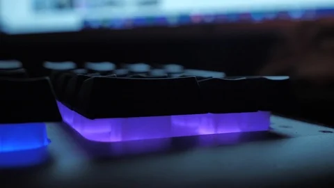 Glowing keyboard hackier style glittering at the night workplace with different Stock Footage 90388047