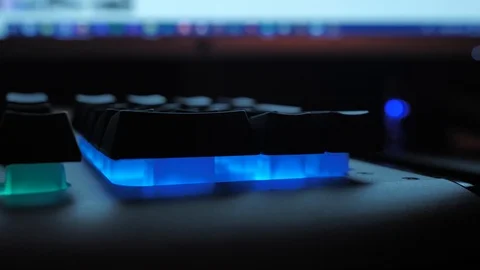 Glowing keyboard hackier style glittering at the night workplace with different Stock Footage 90388283