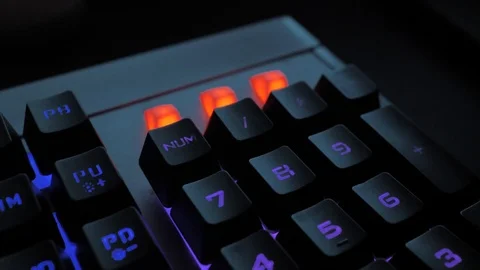 Glowing keyboard hackier style glittering at the night workplace with different Stock Footage 90388656