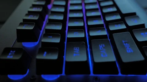 Glowing keyboard hackier style glittering at the night workplace with different Stock Footage 90388763