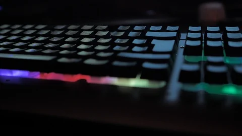 Glowing keyboard hackier style glittering at the night workplace with different Stock Footage 90388846