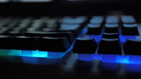 Glowing keyboard hackier style glittering at the night workplace with different Stock Footage 90388972