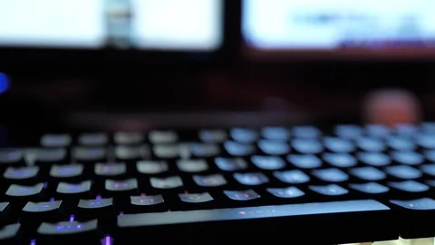 Glowing keyboard hackier style glittering at the night workplace with different Stock Footage 90389040