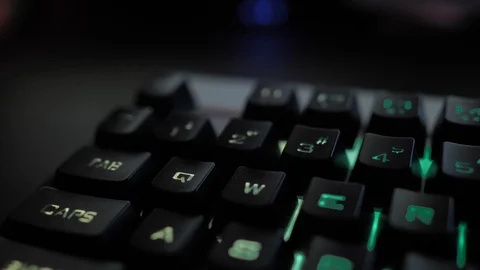 Glowing keyboard hackier style glittering at the night workplace with different Stock Footage 90389087