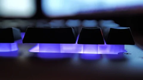 Glowing keyboard hackier style glittering at the night workplace with different Stock Footage 90389187
