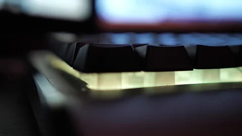 Glowing keyboard hackier style glittering at the night workplace with different Stock Footage 90389352