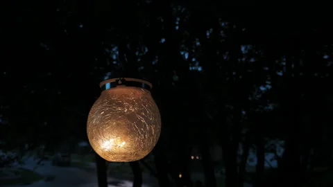 Glowing lantern swaying in the wind on a stormy night Video stock 343561256