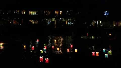 Glowing lanterns floating on the river  in  Hoi An Stock Footage 72294403