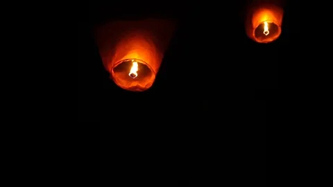 Glowing lanterns fly into the night sky Stock Footage 104047745