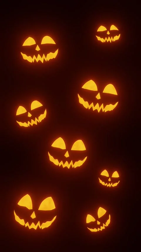 Glowing Laughing Jack O Lantern Pumpkins on Dark Halloween Background Video stock 343800374