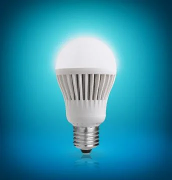 Glowing led bulb on blue background Stock Photos