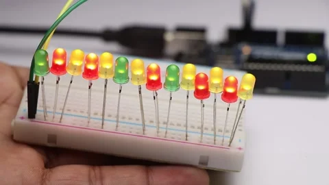 Glowing LED bulbs connected to breadboard controlled by micro controller Stock Footage 156453984