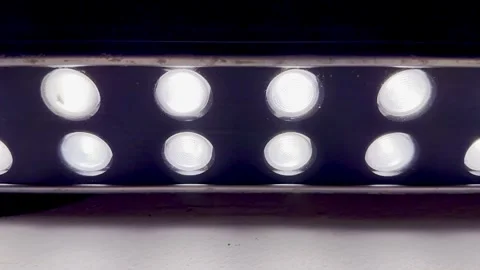 Glowing led light bar row in deep purple ambiance dark studio closeup for tech b Stock Footage 326327202