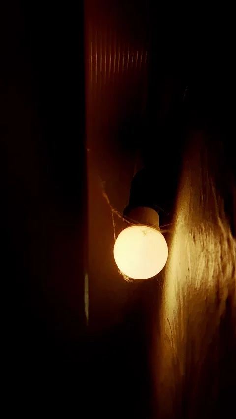 Glowing Light Bulb With Cobwebs in Dark Spooky Room Stock Footage 322534017