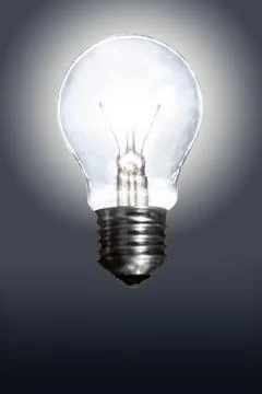 Glowing light bulb on dark background Stock Photos