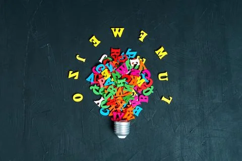 Glowing Light Bulb Made from Multicolored Wooden Letters Stock Photos