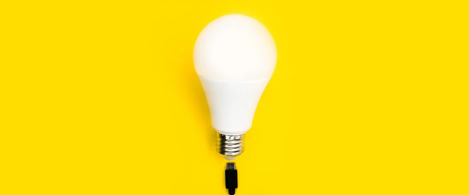 A glowing light bulb. Mockup. Empty space. Beautiful colors. Bright yellow Stock Photos