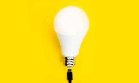A glowing light bulb. Mockup. Empty space. Beautiful colors. Bright yellow Stock Photos