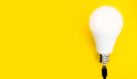 A glowing light bulb. Mockup. Empty space. Beautiful colors. Bright yellow Stock Photos