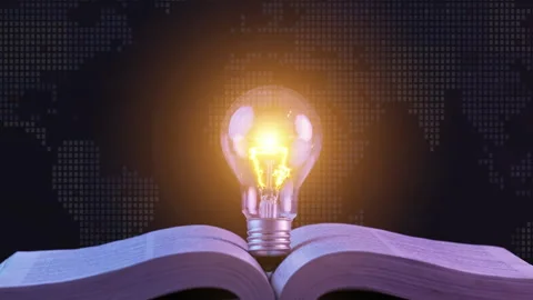 Glowing light bulb on the open book. Inspiring from reading books and education Stock Footage 247164490