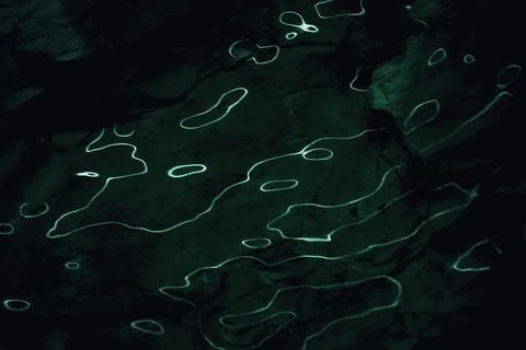 Glowing light lines, abstract light effect , shiny surface on dark background. Stock Photos