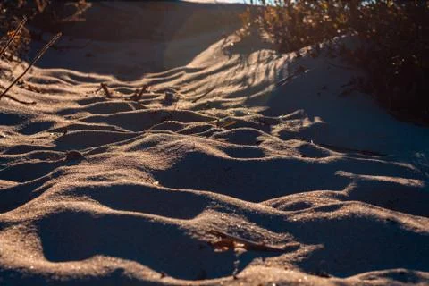 Glowing light passing though the sand on a beach Stock Photos
