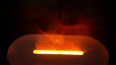 Glowing Light with Smoke in Dark Background, Close-up of an orange glowing .. Stock Footage 304875774