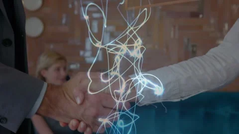 Glowing light trails over mid section of businessman and businesswoman shaking Stock Footage 328977224