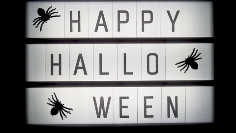 Glowing lightbox with text Happy halloween and spiders Stock Footage 116590729
