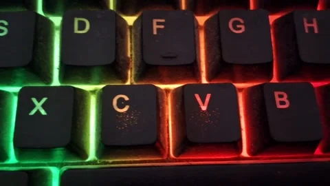 Glowing mechanical keyboard keys shifting colors in dynamic motion video footage Stock Footage 337844161