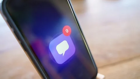 Glowing message app icon with unread badge on smartphone lying on table. Stock Footage 342810817